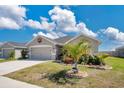 Charming single-story home boasts a two-car garage, well-kept lawn, and tropical landscaping in a desirable neighborhood at 11820 Stone Pine St, Riverview, FL 33569