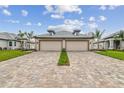 Symmetrical home exterior featuring two-car garages, brick driveways and perfectly manicured lawns and landscaping at 18032 Cherished Loop, Bradenton, FL 34211
