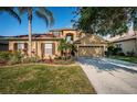 Inviting home with well-maintained landscaping, and warm exterior paint, perfect for any buyer at 3033 Stonegate Falls Dr, Land O Lakes, FL 34638