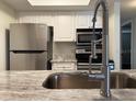 Modern kitchen featuring stainless steel appliances and granite countertops at 3102 W Horatio St # 12, Tampa, FL 33609