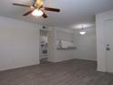 Open-concept living room boasts wood floors, ceiling fan, and a bar overlooking the kitchen at 3102 W Horatio St # 21, Tampa, FL 33609