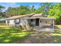 View of the home's exterior, showcasing a covered carport and a tidy, inviting entryway at 3703 Cooper Rd, Plant City, FL 33565