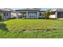 The backyard features a well-maintained lawn, covered patio and lake views at 17245 Savory Mist Cir, Bradenton, FL 34211