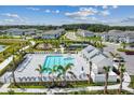 Aerial view of community pool, playground, tennis courts, and well-manicured landscaping at 1933 Transom Ln, Sarasota, FL 34240