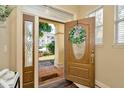 Inviting foyer featuring hardwood floors, a decorative front door, and plenty of natural light at 4604 W Fig St # 1, Tampa, FL 33609