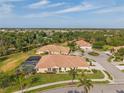 Expansive aerial view of a residential neighborhood showcasing large homes with well-maintained lawns and landscaping at 5599 Hidden Oak Ct, North Port, FL 34287