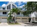 Inviting townhouse with attached garages, lush landscaping, and a modern architectural design at 9874 Indian Key Trl # 62, Seminole, FL 33776