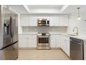 Modern kitchen boasts stainless steel appliances, sleek countertops, and ample cabinet space at 9874 Indian Key Trl # 62, Seminole, FL 33776