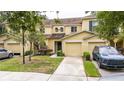 Charming two-story townhome with a single-car garage, inviting entrance, and well-maintained landscaping at 10821 Great Carlisle Ct, Riverview, FL 33578