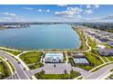 Expansive view of the lakefront community, highlighting the pool, tennis courts, and surrounding residences at 1758 Spreader Ln, Sarasota, FL 34240
