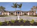Beautiful community entrance with palm trees, lush landscaping, and a welcoming gate at 18064 Cherished Loop, Bradenton, FL 34211