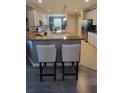 Eat-in kitchen features granite countertops, stainless appliances, white cabinetry, and modern lighting at 227 Heritage Preserve Run, Bradenton, FL 34212