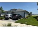 Charming single-story home with a two-car garage, paved driveway, and well-maintained landscaping at 43819 Cattleman Dr, Punta Gorda, FL 33982