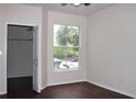 Bright bedroom features hardwood floors, large window, and closet with shelving at 5613 Legacy Crescent Pl # 201, Riverview, FL 33578