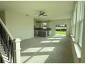 Spacious living room with abundant natural light, ceiling fan and an open-concept layout to the kitchen at 13610 Wolfpack Rd, Hudson, FL 34667