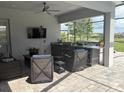 Outdoor kitchen features modern appliances, a bar, and a seating area, perfect for entertaining guests at 16617 5Th E Ave, Bradenton, FL 34212