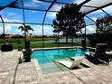 Screened pool offers a relaxing outdoor space with views of the lush backyard and serene lake at 16617 5Th E Ave, Bradenton, FL 34212