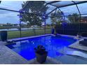 Evening view of the pool illuminated with blue lights, creating a relaxing and inviting atmosphere at 16617 5Th E Ave, Bradenton, FL 34212