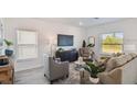 Bright living room featuring modern furnishings, neutral color palette and large windows offering plenty of natural light at 16836 Fiesta Dr, Port Charlotte, FL 33953