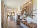 Inviting hallway with modern decor, leading to the kitchen and dining area; wood-look flooring at 2046 Sunset Preserve Way, Port Charlotte, FL 33953