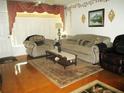 Comfortable living room with ample seating, a decorative rug and curtains at 4154 57Th N St # 272, Kenneth City, FL 33709