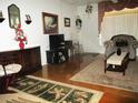 Inviting living room with wood floors, patterned rug, and a cozy armchair at 4154 57Th N St # 272, Kenneth City, FL 33709
