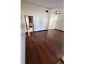 Open-concept living room with hardwood floors and vaulted ceilings, offering a bright and airy feel at 5552 Pentail Cir, Tampa, FL 33625