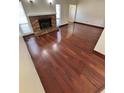 Spacious living room with hardwood floors and a cozy fireplace, creating a warm and inviting atmosphere at 5552 Pentail Cir, Tampa, FL 33625
