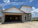 New construction shows concrete walls with Tyvek wrap, offering a glimpse into the building process and the home's structure at 7979 Chandler Lake Ct, Hudson, FL 34667