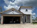 Unfinished new construction home featuring block construction, modern door, and an attached garage at 7979 Chandler Lake Ct, Hudson, FL 34667