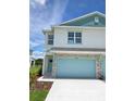 New two-story townhome with two-car garage and landscaped front yard at 13964 Emerald Fields Dr, Hudson, FL 34667