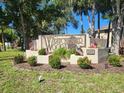 Westchester Woods community sign surrounded by lush landscaping and American flags at 22481 Westchester Blvd # A19, Punta Gorda, FL 33980