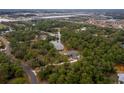 High angle aerial shot overlooking a secluded home, ponds, and surrounding neighborhoods at 233 Snyder Dr, Venice, FL 34292