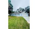 A well-kept single-story home with a white garage door and a neatly trimmed lawn at 4934 Avery Rd, New Port Richey, FL 34652