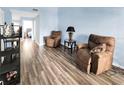 Relaxing living room with two brown recliner chairs and wood-look flooring at 304 34Th Avenue E Dr # 304, Bradenton, FL 34208