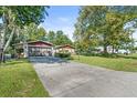 Ranch-style home with attached garage and a long driveway at 12444 Coronado Dr, Spring Hill, FL 34609