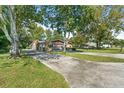 Ranch-style home with attached garage and a long driveway at 12444 Coronado Dr, Spring Hill, FL 34609