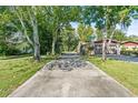 Ranch-style home with attached garage and a long driveway at 12444 Coronado Dr, Spring Hill, FL 34609