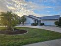 House exterior featuring a metal roof and landscaping at 975 Coronado Dr, Punta Gorda, FL 33950