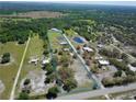 Aerial view of a large property with multiple buildings and acreage at 40610 State Road 64 E, Myakka City, FL 34251
