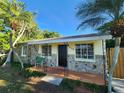 House with stone exterior, a wooden door, and a landscaped yard at 2309 22Nd W Ave, Bradenton, FL 34205