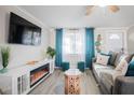 Cozy living room featuring a fireplace, comfortable sofa, and large TV at 4615 Lords Ave, Sarasota, FL 34231