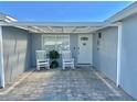 Charming front porch with rocking chairs, a paved patio, and a pergola at 4229 Floramar Ter, New Port Richey, FL 34652