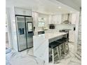 Modern kitchen with stainless steel appliances and a large quartz island at 4229 Floramar Ter, New Port Richey, FL 34652