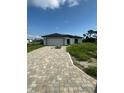 Newly constructed home with driveway and unlandscaped yard at 12122 Clarendon Ave, Port Charlotte, FL 33981