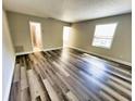 Bright and airy living room with wood-look floors at 13824 Orange Sunset Dr # 202, Tampa, FL 33618