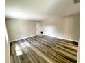 Large living area with wood-look floors and neutral walls at 13824 Orange Sunset Dr # 202, Tampa, FL 33618