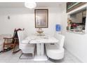 Casual dining area with white table and bench seating at 4222 Trucious Pl # 4222, New Port Richey, FL 34652