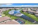 Aerial view of a residential community with a scenic pond and a water fountain feature at 17518 Canopy Pl, Bradenton, FL 34211
