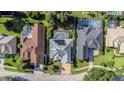 Aerial view of homes showcasing a neighborhood with pools and lush landscaping at 2228 Valrico Forest Dr, Valrico, FL 33594